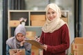 Beautiful young working woman in hijab standing in office, smiling. Portrait of confident muslim businesswoman. Modern Royalty Free Stock Photo