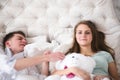 A beautiful younge couple in bed are having fun