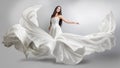 Beautiful young girl in flying white dress. Flowing fabric. Light white cloth flying Royalty Free Stock Photo