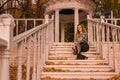 A beautiful youth is standing, an adult with a charismatic appearance, a blonde in a colored shirt, standing, against Royalty Free Stock Photo