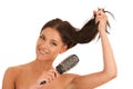 Beautiful ypoung woman combs her hair isolated over white background