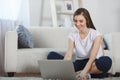 Beautiful ypung woman using laptop at home