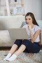 Beautiful ypung woman using laptop at home