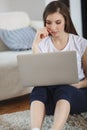 Beautiful ypung woman using laptop at home