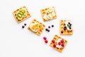 Beautiful yummy snacks. Waffles with cream and friuits on white background top-down Royalty Free Stock Photo