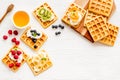 Beautiful yummy snacks. Waffles with cream and friuits on white background top-down frame copy space Royalty Free Stock Photo