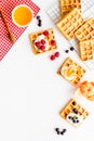 Beautiful yummy snacks. Waffles with cream and friuits on white background top-down frame copy space Royalty Free Stock Photo