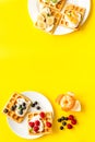 Beautiful yummy snacks. Waffles with cream and friuits on yellow background top-down frame copy space Royalty Free Stock Photo