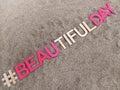 #beautifulday beautiful day written on sand at the beach Royalty Free Stock Photo