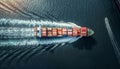 Beautifull aerial drone point view to full loaded Container ship going ocean gulf waves leaving foamy trace. International cargo Royalty Free Stock Photo