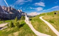 Beautifull aerial panoramic view to path to small white chapel San Maurizio and Dolomiti mountain landscape in background. Selva Royalty Free Stock Photo