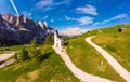 Beautifull aerial panoramic view to path to small white chapel San Maurizio and Dolomiti mountain landscape in background. Selva Royalty Free Stock Photo