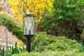 Beautifull black garden lantern on a lag in the green garden