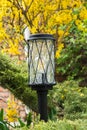 Beautifull black garden lantern on a lag in the green garden