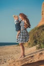 Beautifull mother lady with cute daughter girl on a beach sea side stylush dressed