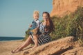 Beautifull mother lady with cute daughter girl on a beach sea side stylush dressed