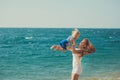 Beautifull mother lady with cute daughter girl on a beach sea side stylush dressed