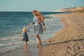 Beautifull mother lady with cute daughter girl on a beach sea side stylush dressed