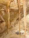 Picture with icicles on sandstone wall, blurred background