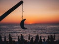 Beautifull sunrise in Thasos, Greece with the sun rising from the sea, tourists on the beach watching the sunrise and a model moon