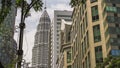 Beautiful view of the stunning Petronas Tower emerging majestic over KLCC district office buildings on a sunny day