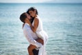 Beautiful wedding couple kissing and embracing in turquoise water, mediterranean sea in Greece. Royalty Free Stock Photo