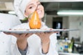 A beautifull young chef posing with a meal