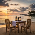 Romantic beach dinner setup at sunset with lanterns and wine Royalty Free Stock Photo