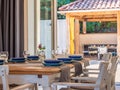 Beautifully arranged dinner table with blue plates near a patio