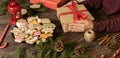 Beautifully arranged table in Christmas and New Year motives, traditionally shaped cookies and biscuits glazed in sugar icing with