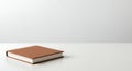 Minimalist brown book mockup on white table Royalty Free Stock Photo