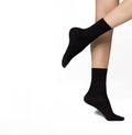 Beautifully cared feminine legs in a black short nylon socks Royalty Free Stock Photo