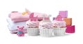 Beautifully decorated baby shower cupcakes for girl, clothes and toys on white background
