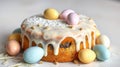 Easter cake adorned with pastel eggs and icing on a white background for festive celebration Royalty Free Stock Photo