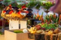 Beautifully decorated catering banquet table with different food snacks and appetizers with sandwich, caviar, fresh fruits on corp Royalty Free Stock Photo