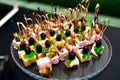 Beautifully decorated catering banquet table with different food snacks and appetizers with sandwich, caviar, fresh fruits on