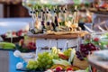 Beautifully decorated catering banquet table with different food snacks and appetizers with sandwich, caviar, fresh fruits on corp Royalty Free Stock Photo