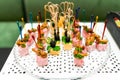 Beautifully decorated catering banquet table with different food snacks and appetizers with sandwich, caviar, fresh fruits on