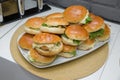 Beautifully decorated catering banquet table with different hamburgers burgers sandwiches on a plate on corporate birthday . Mini Royalty Free Stock Photo