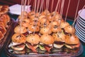 Beautifully decorated catering banquet table with different hamburgers burgers sandwiches on a plate on corporate christmas birthd Royalty Free Stock Photo