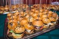 Beautifully decorated catering banquet table with different hamburgers burgers sandwiches on a plate on corporate christmas birthd Royalty Free Stock Photo