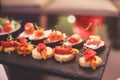 Beautifully decorated catering banquet table with different food snacks and appetizers with sandwich, caviar, fresh fruits