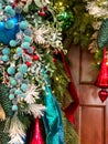 Colorful Christmas swag by brown wall Royalty Free Stock Photo