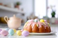 Beautifully decorated Easter bundt cake with white frosting and pastel colored sugar eggs. Glazed donut cake for Easter