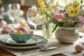 Beautifully decorated Easter dinner table with colorful flowers, pastel crockery and dyed eggs. Indoor Easter celebration party