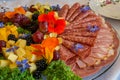 Beautifully decorated home made  salads with edible flowers  on table with different food snacks  party Royalty Free Stock Photo