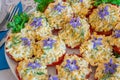 Beautifully decorated home made  salads with edible flowers  on table with different food snacks  party Royalty Free Stock Photo