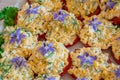 Beautifully decorated home made  salads with edible flowers  on table with different food snacks  party Royalty Free Stock Photo