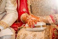 Beautifully decorated Indian bride hands with the groom.