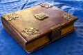 Beautifully decorated old book brown gold with lock on blue background Royalty Free Stock Photo